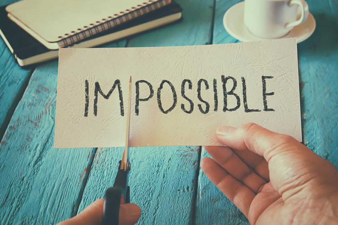 . A paper with the word "impossible" written on it, with the letters "im" highlighted to show the potential for change.